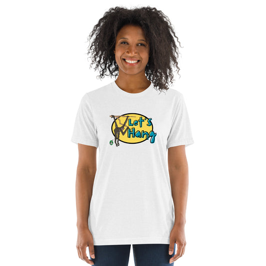 A woman standing wearing a white tee shirt with a printed graphic of a monkey hanging on a branch with the words, Let's Hang. Designed by Wizard Prints