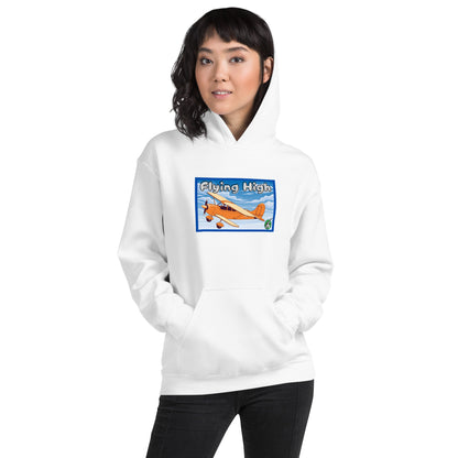 A woman standing wearing a white hoodie with the printed graphic of a vintage airplane and the words, Flying High, by Wizard Prints